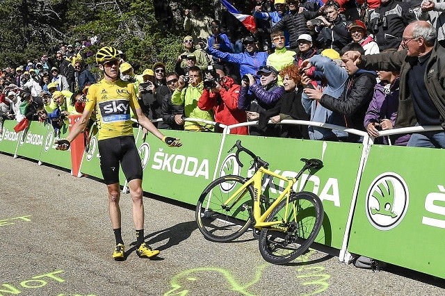Chris Froome wacht op een eigen fiets.